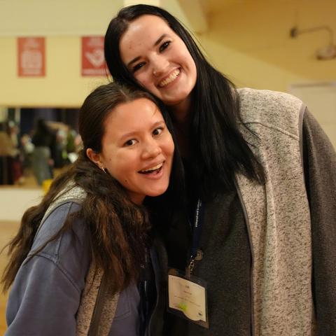 Two students posing together and smiling at the camera.